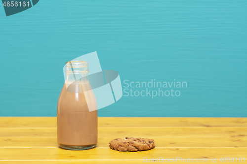 Image of Chocolate milkshake in a milk bottle and a chocolate chip cookie
