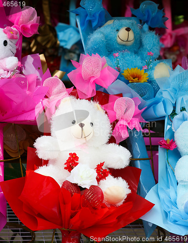 Image of Cute stuffed toys and flowers.