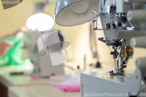 Image of close-up of the needle sewing machine in the workshop atelier