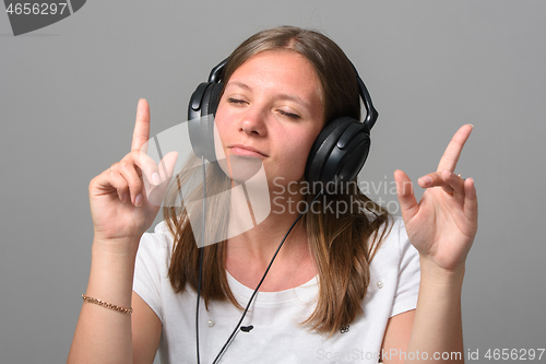 Image of Portrait of a girl listening to music on headphones
