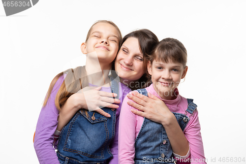 Image of Mom happily clung to her daughters, isolated on white background