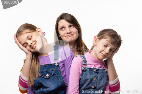 Image of Mom holds the heads of children on the palms, isolated on a white background