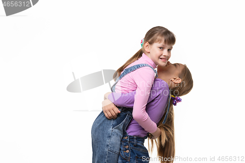 Image of Girl lifted and hugged another a girl