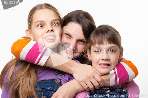 Image of Mom hugged and squeezed the necks of children, isolated on white background