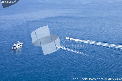 Image of View of boats sailing across the blue clear waters of Adriatic S