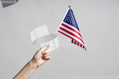 Image of Human hand holding USA flag