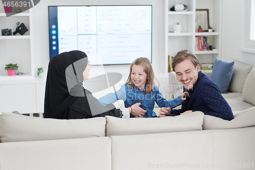 Image of Happy Muslim family having fun at home