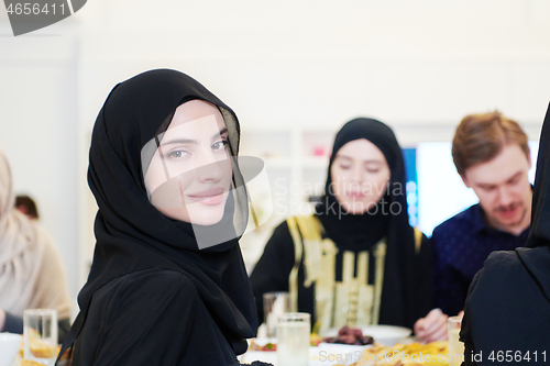 Image of young muslim woman having Iftar dinner with family