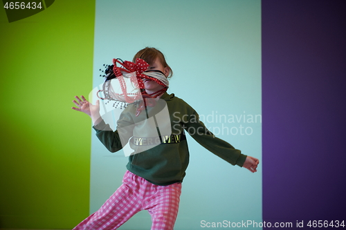 Image of girl having fun and dancing wearing mothers jewelry
