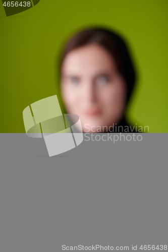 Image of Woman in Abaya Holding a Date Fruit and glass of water