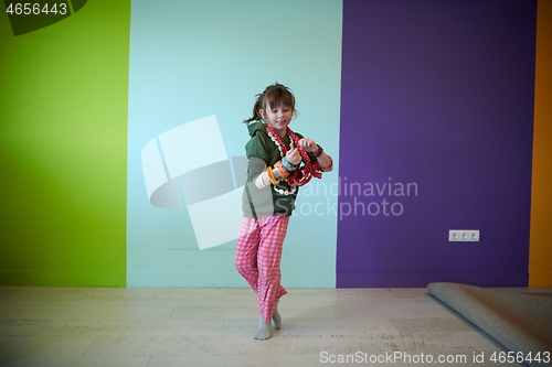 Image of girl having fun and dancing wearing mothers jewelry