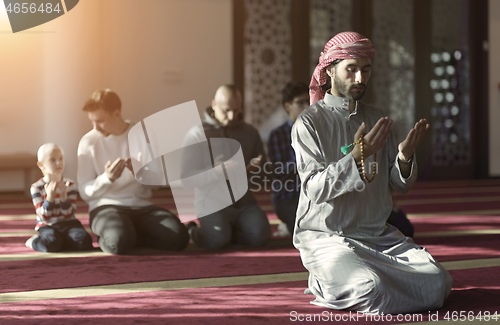 Image of muslim people praying in mosque