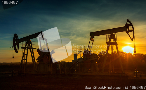 Image of Two working oil pumps silhouette