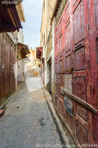 Image of Old street with red door in Fes medina