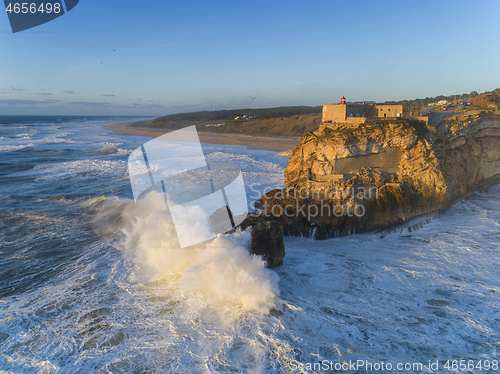 Image of Lighthouse and big waves at in Nazare