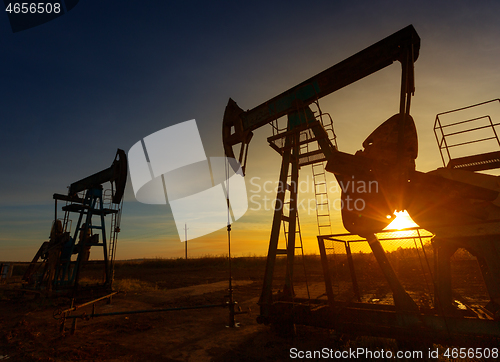 Image of Two working oil pumps silhouette