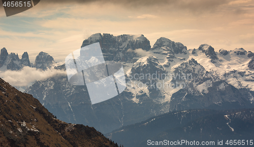 Image of Snow-capped alps mountains in clouds