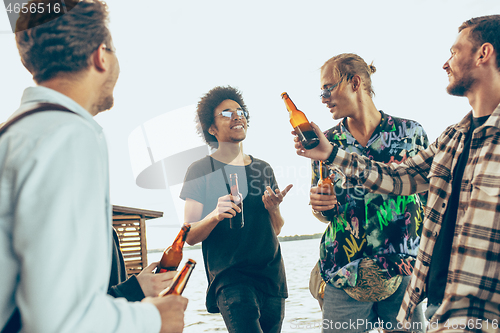 Image of Group of friends celebrating, resting, having fun and party in summer day