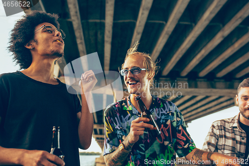 Image of Group of friends celebrating, resting, having fun and party in summer day