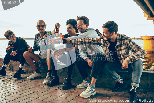 Image of Group of friends celebrating, resting, having fun and party in summer day