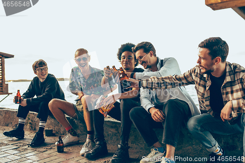 Image of Group of friends celebrating, resting, having fun and party in summer day