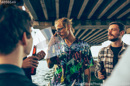 Image of Group of friends celebrating, resting, having fun and party in summer day