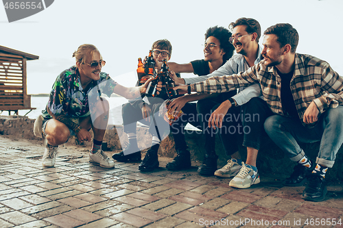 Image of Group of friends celebrating, resting, having fun and party in summer day