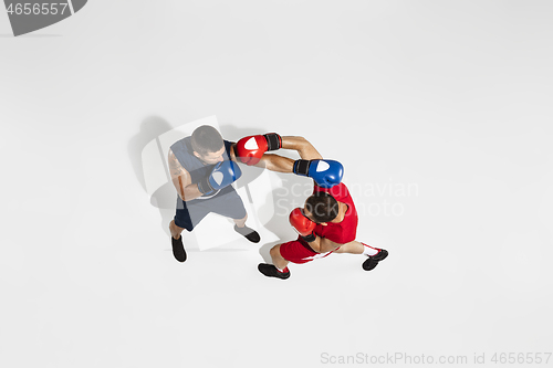 Image of Two professional boxers boxing isolated on white studio background, action, top view