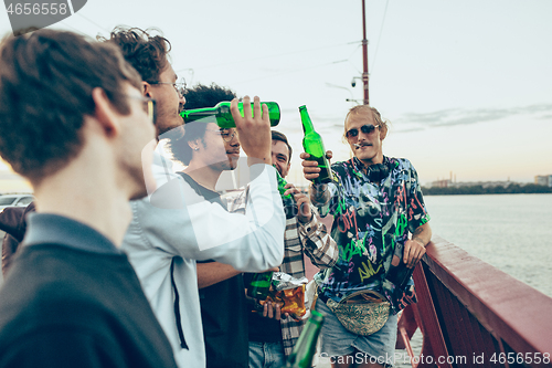 Image of Group of friends celebrating, resting, having fun and party in summer day