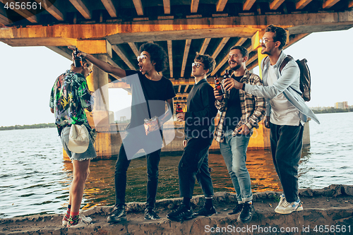 Image of Group of friends celebrating, resting, having fun and party in summer day