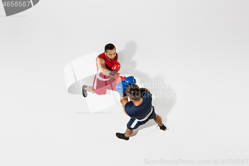 Image of Two professional boxers boxing isolated on white studio background, action, top view