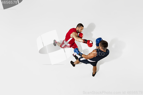 Image of Two professional boxers boxing isolated on white studio background, action, top view