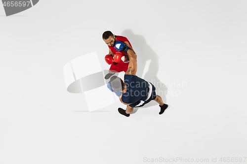 Image of Two professional boxers boxing isolated on white studio background, action, top view