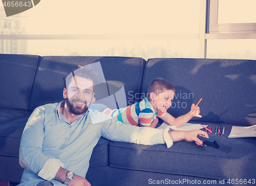 Image of Happy Young Family Playing Together on sofa