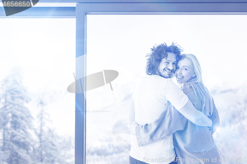 Image of young couple enjoying morning coffee by the window