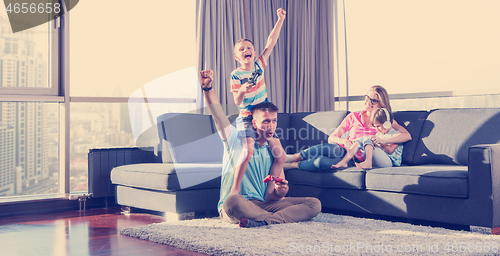 Image of Happy family playing a video game