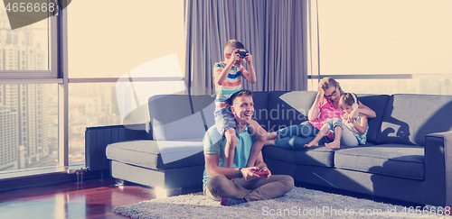 Image of Happy family playing a video game