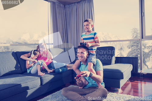 Image of Happy family playing a video game