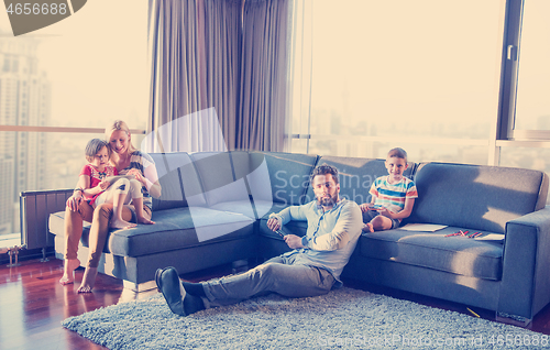 Image of Happy Young Family Playing Together on sofa