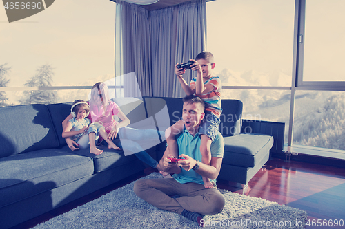 Image of Happy family playing a video game