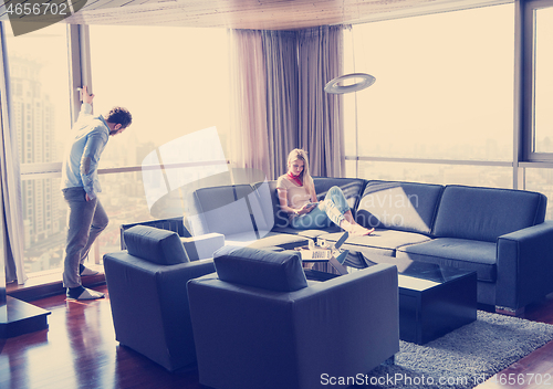 Image of couple relaxing at  home using tablet computer