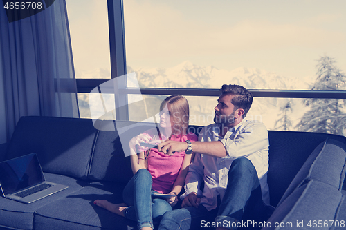 Image of Young couple watching television