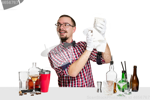 Image of Expert barman is making cocktail at studio