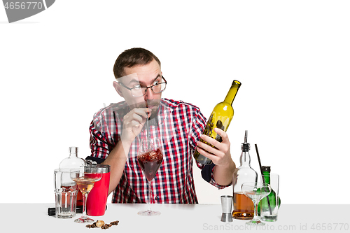 Image of Expert barman is making cocktail at studio