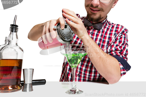 Image of Expert barman is making cocktail at studio