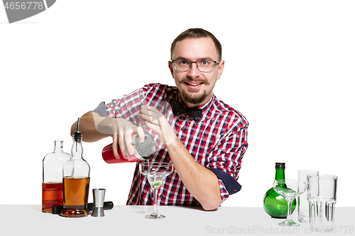 Image of Expert barman is making cocktail at studio