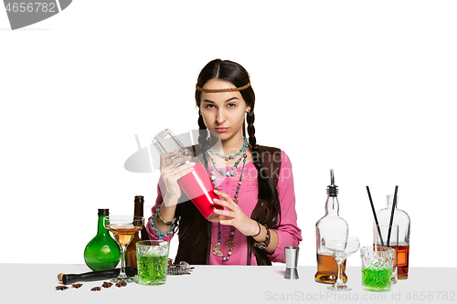 Image of Expert female barman is making cocktail at studio