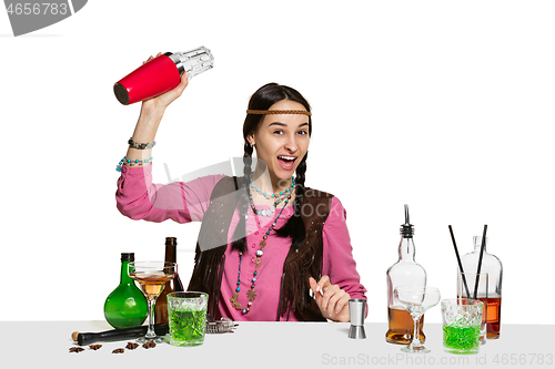 Image of Expert female barman is making cocktail at studio