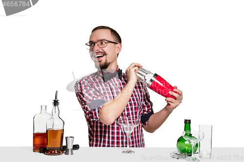 Image of Expert barman is making cocktail at studio