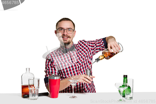 Image of Expert barman is making cocktail at studio